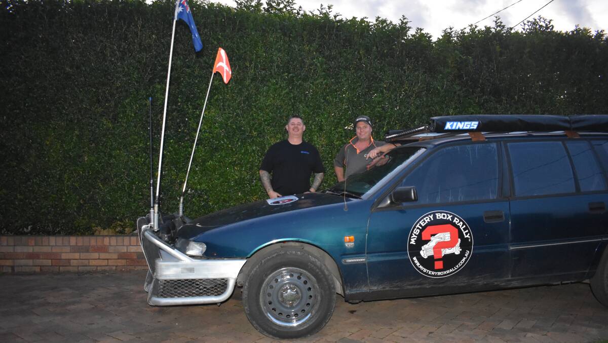Jamie Allen (left) and Adam Kraski posed in front of the car they will do the Mystery Box Rally in. Picture by Angus Michie