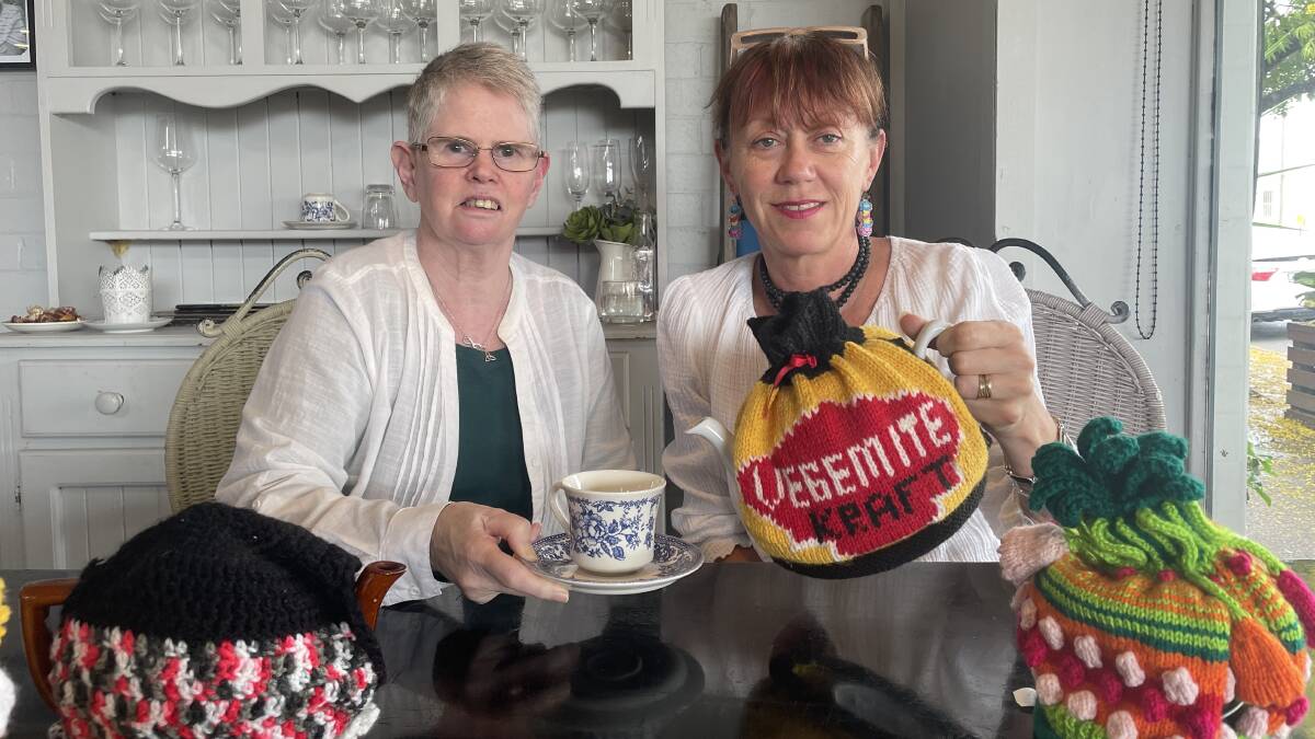 The Dungog Tea Party president Erika Seck (right) and secretary Pauline Cambourne (left) with some fancy tea cosies.