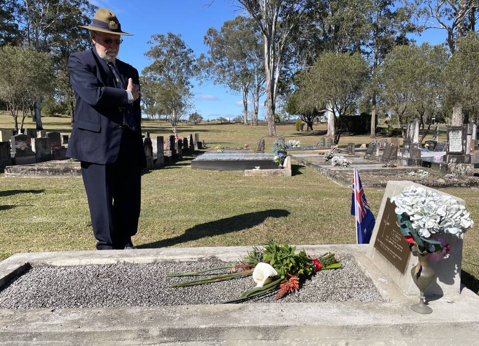 Dungog RSL Sub-Branch's vice president Nick Helyer paying his respects at Private Edward Anthony Grills' grave in Stroud Cemetery. Picture by Angus Michie