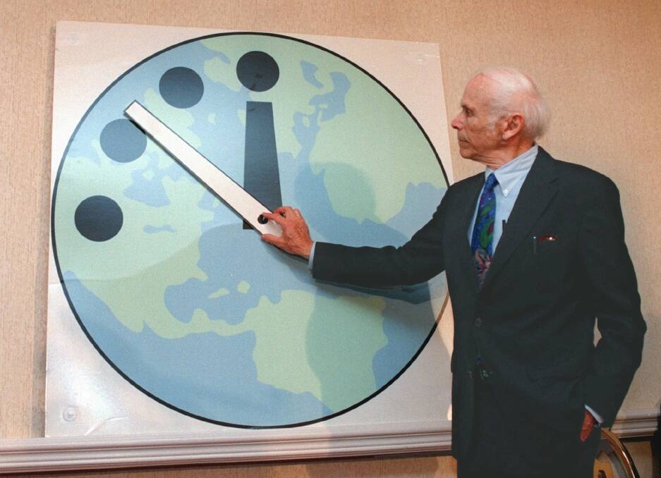 Leonard Rieser, chairman of the Board of the Bulletin of the Atomic Scientists and a member of the Manhattan Project that developed the first atomic bomb during World War II, moves the minute hand to 11:51 p.m. on the Doomsday Clock, five minutes closer to midnight Thursday, June 11, 1998 in Chicago.