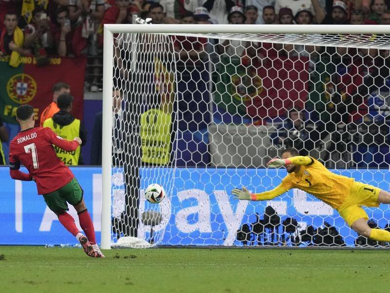 Portugal's Cristiano Ronaldo (left) scored in the penalty shootout win over Slovenia. (AP PHOTO)