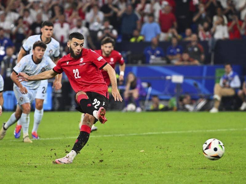 Georgia's Georges Mikautadze scores from the penalty spot in his side's 2-0 win over Portugal. (AP PHOTO)
